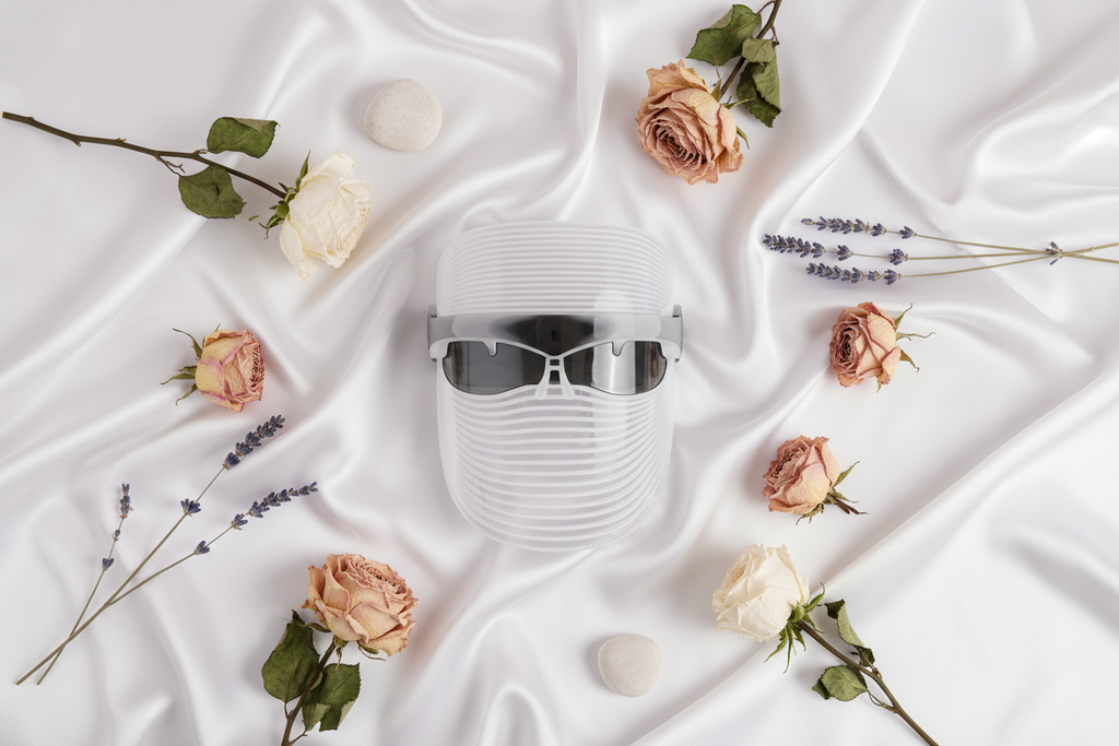 LUMIVÉ GlowPro LED light therapy mask flat lay with accessories and controller
